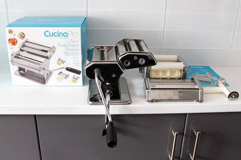 CucinaPro Pasta Maker Deluxe with freshly made pasta on counter