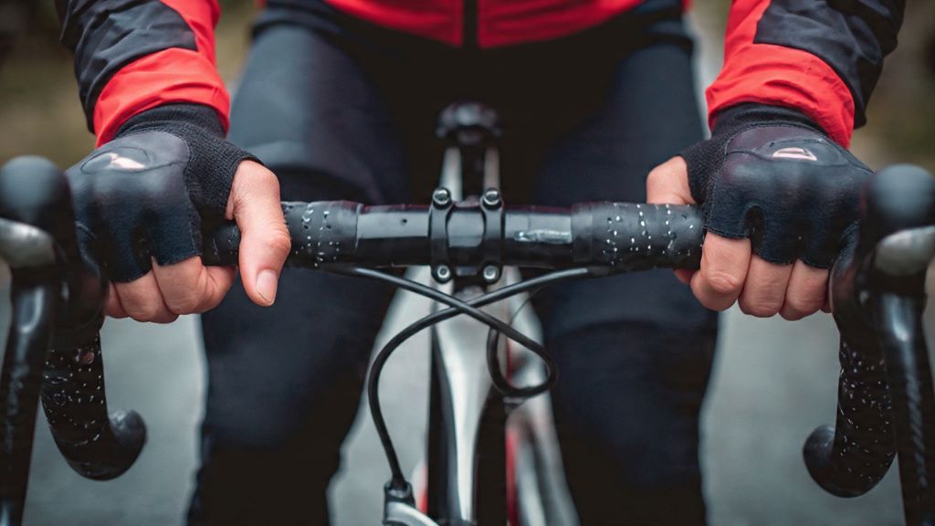 2. Close-up view of padded cycling gloves on road bike handlebars with gel padding for vibration dampening