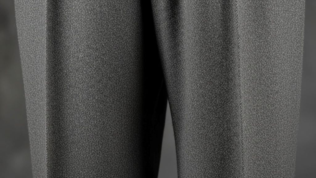 Close-up of authentic 1920s Oxford bags trousers showing characteristic wide leg opening and wool fabric