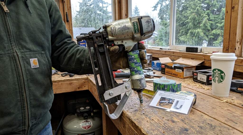 DIY homeowner applying anti-rust coating to a framing nail gun for wet Pacific Northwest conditions
